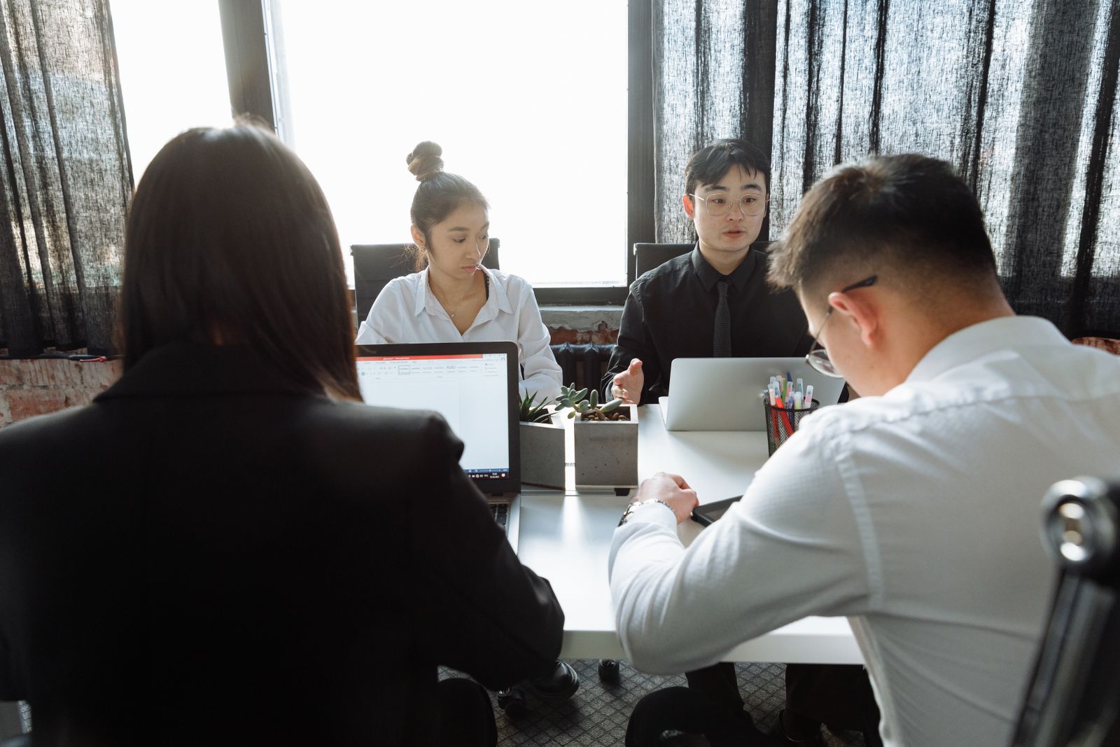 Professionals discussing work together around a table